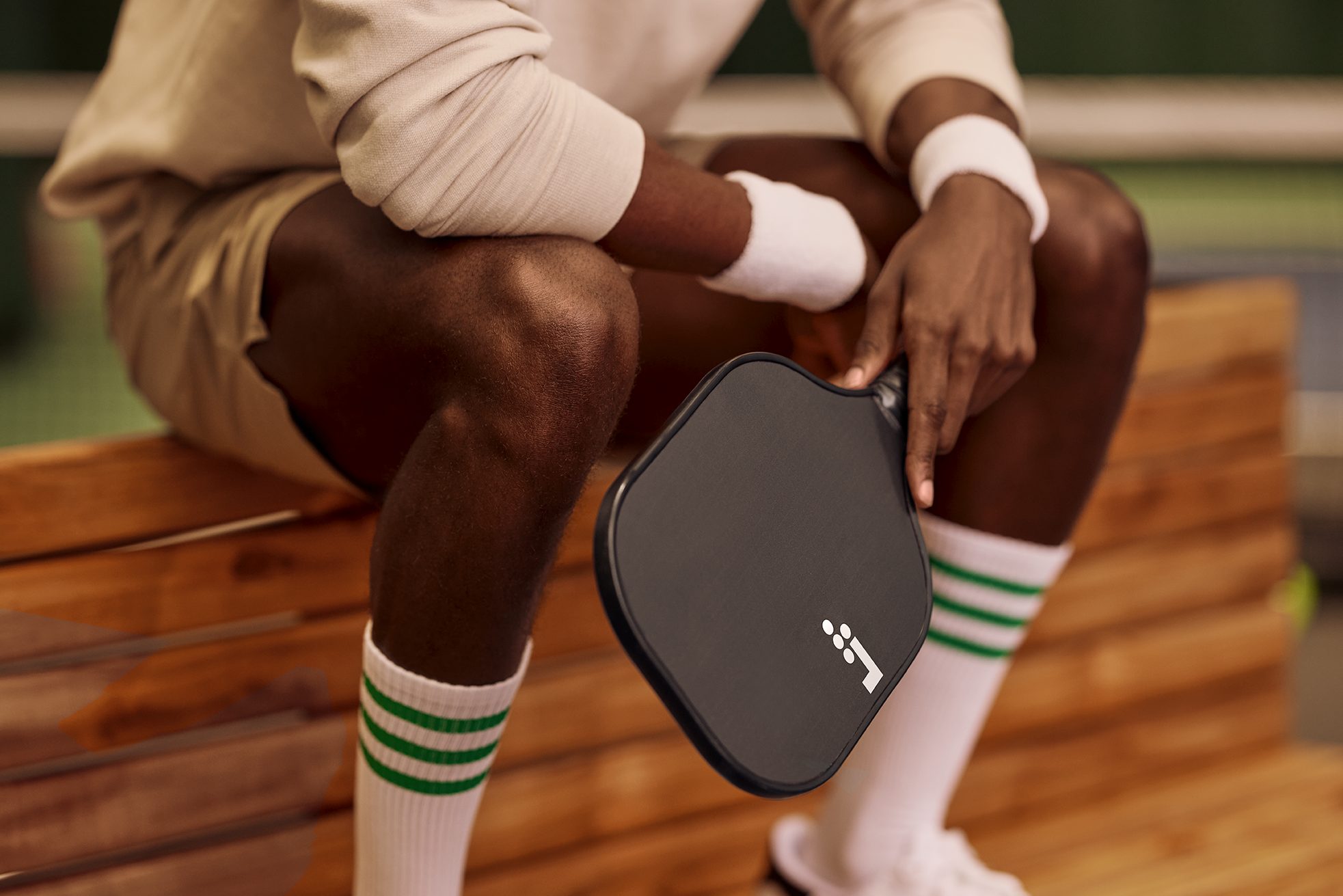 a man holding a pickleball racquet