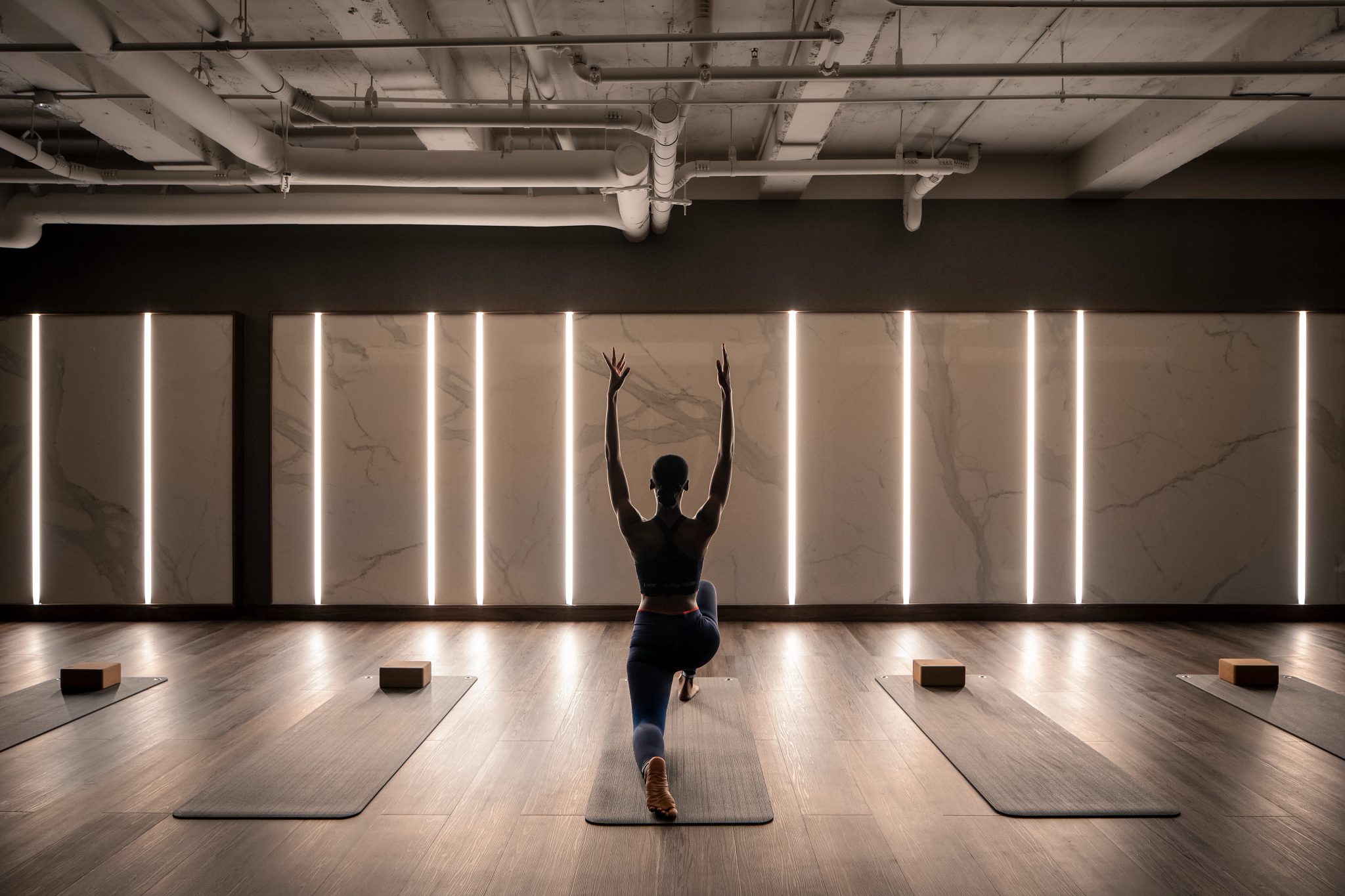 a woman doing a yoga pose in class
