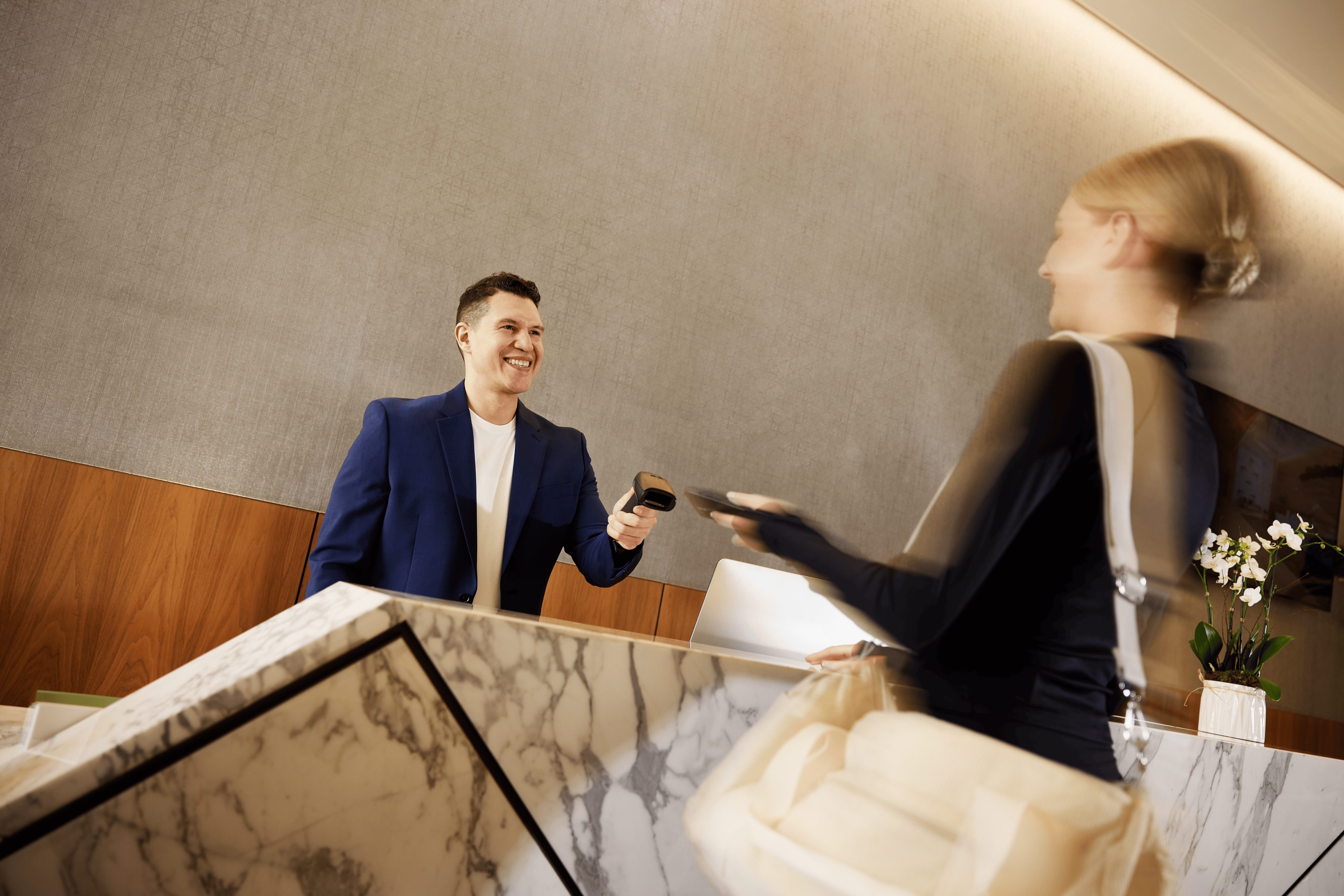 a concierge team member checking a member into the club