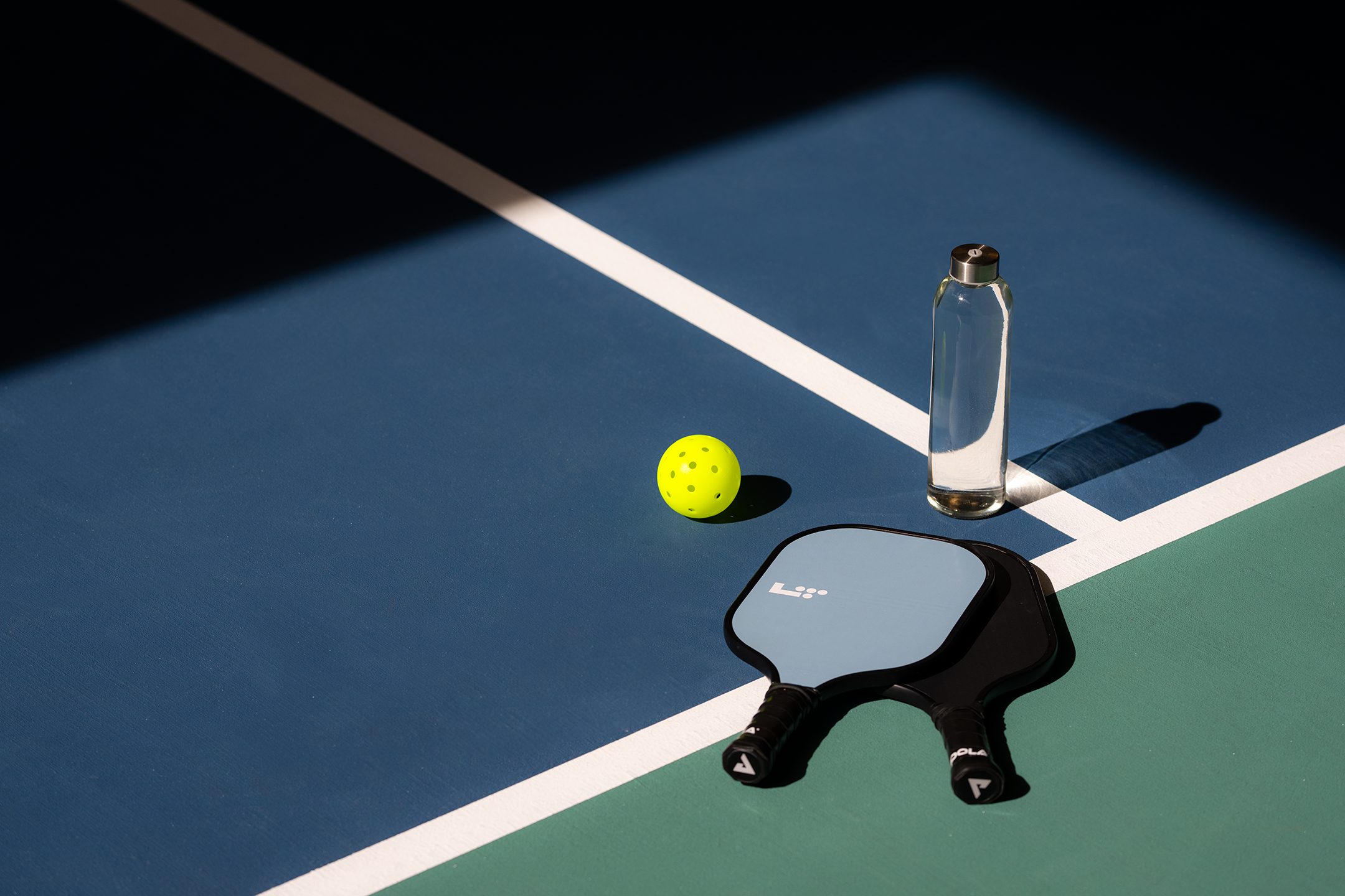 pickleball paddle sitting on a court