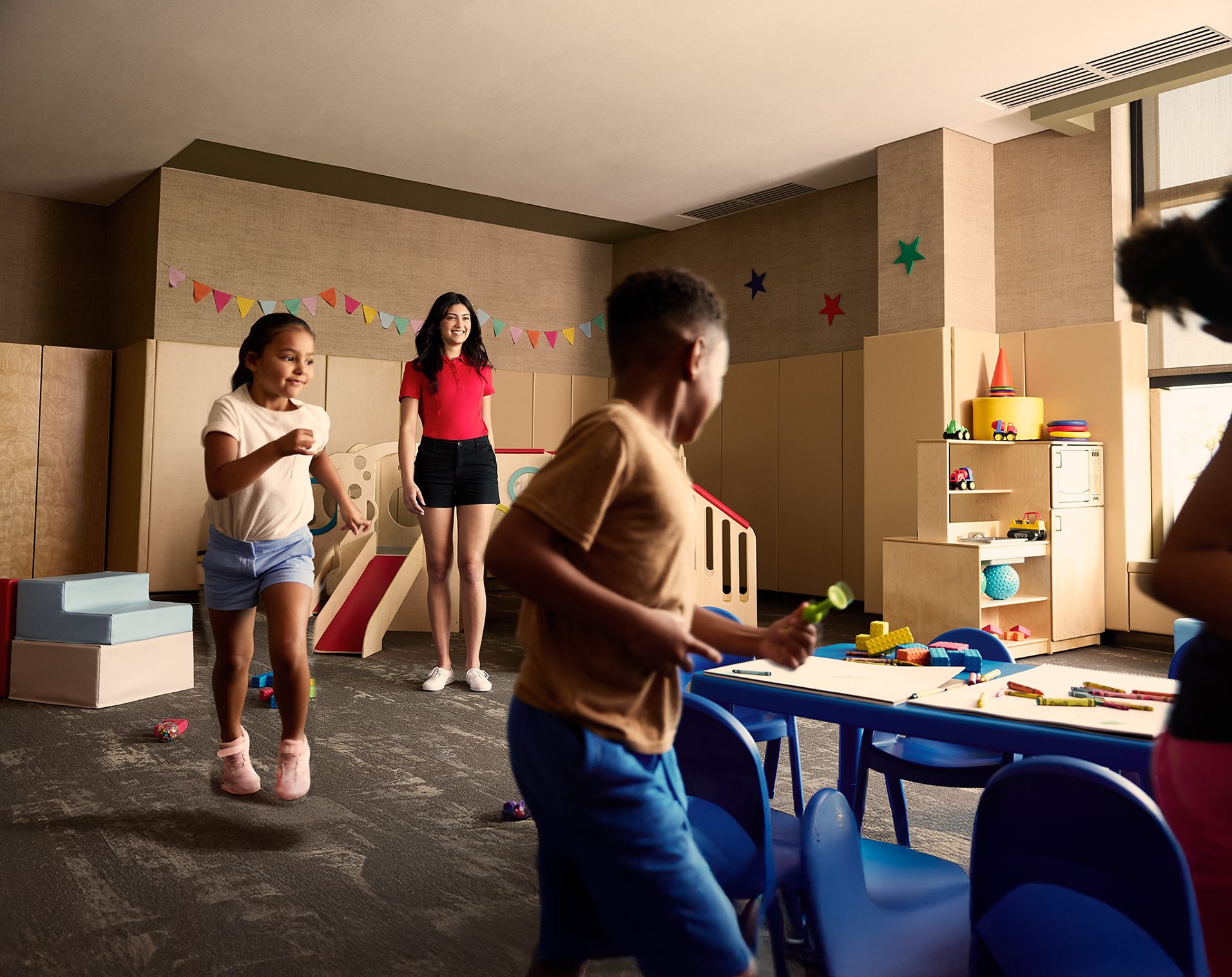 kids playing in a room with blue chairs
