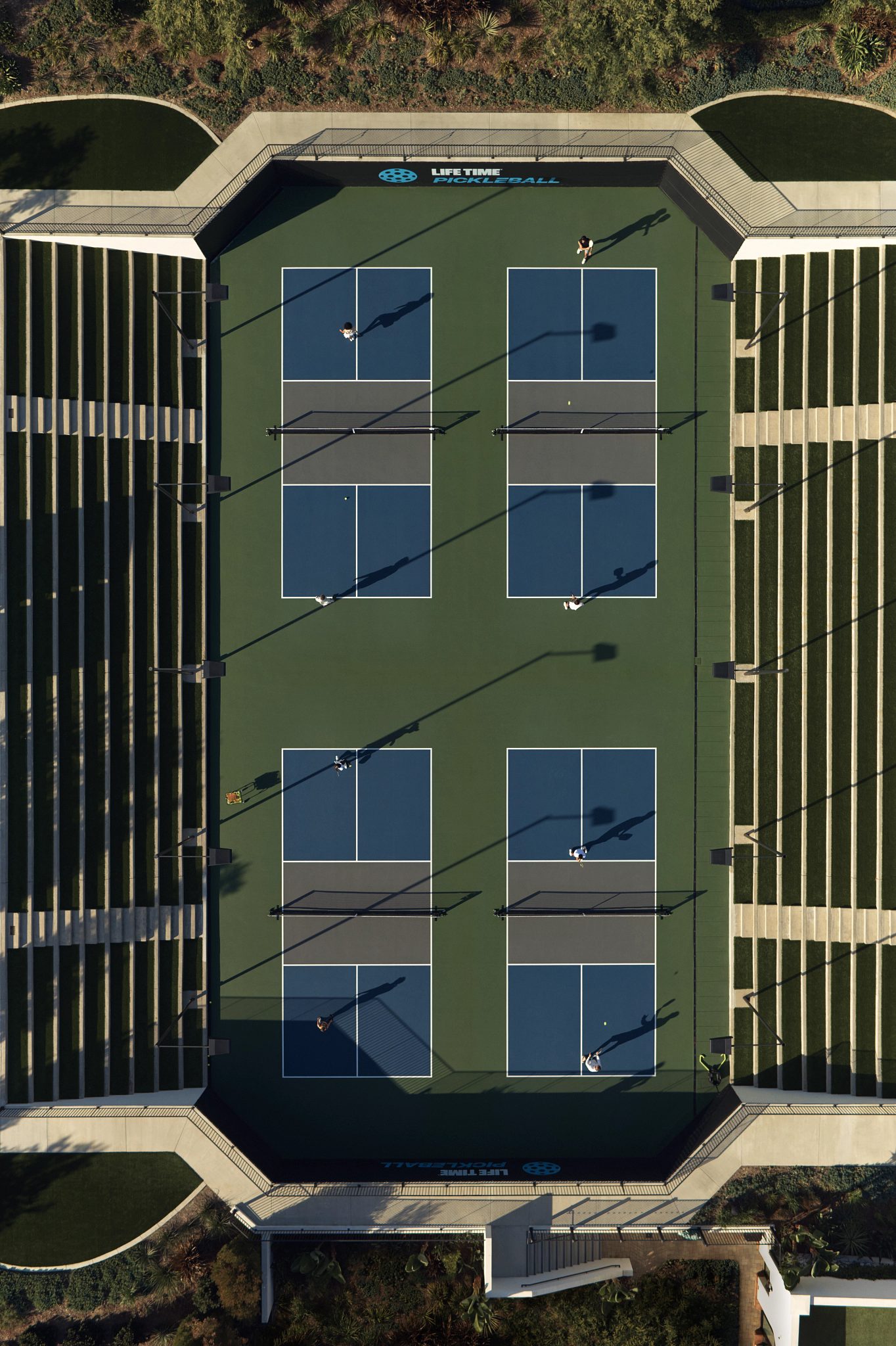 An aerial view of Life Time members playing on four pickleball courts