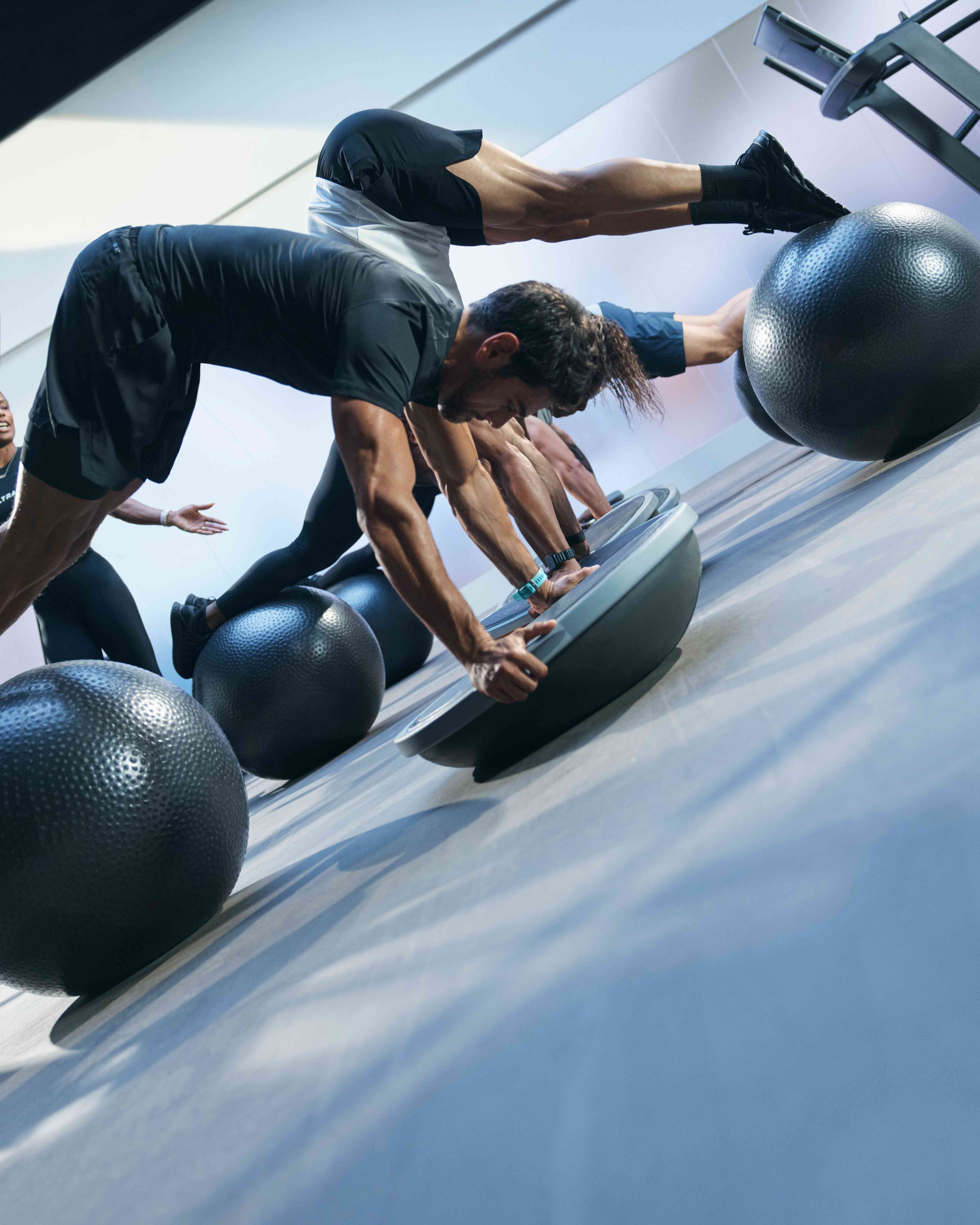 Class using bosu balls and yoga balls in an UltraFit boutique group training class