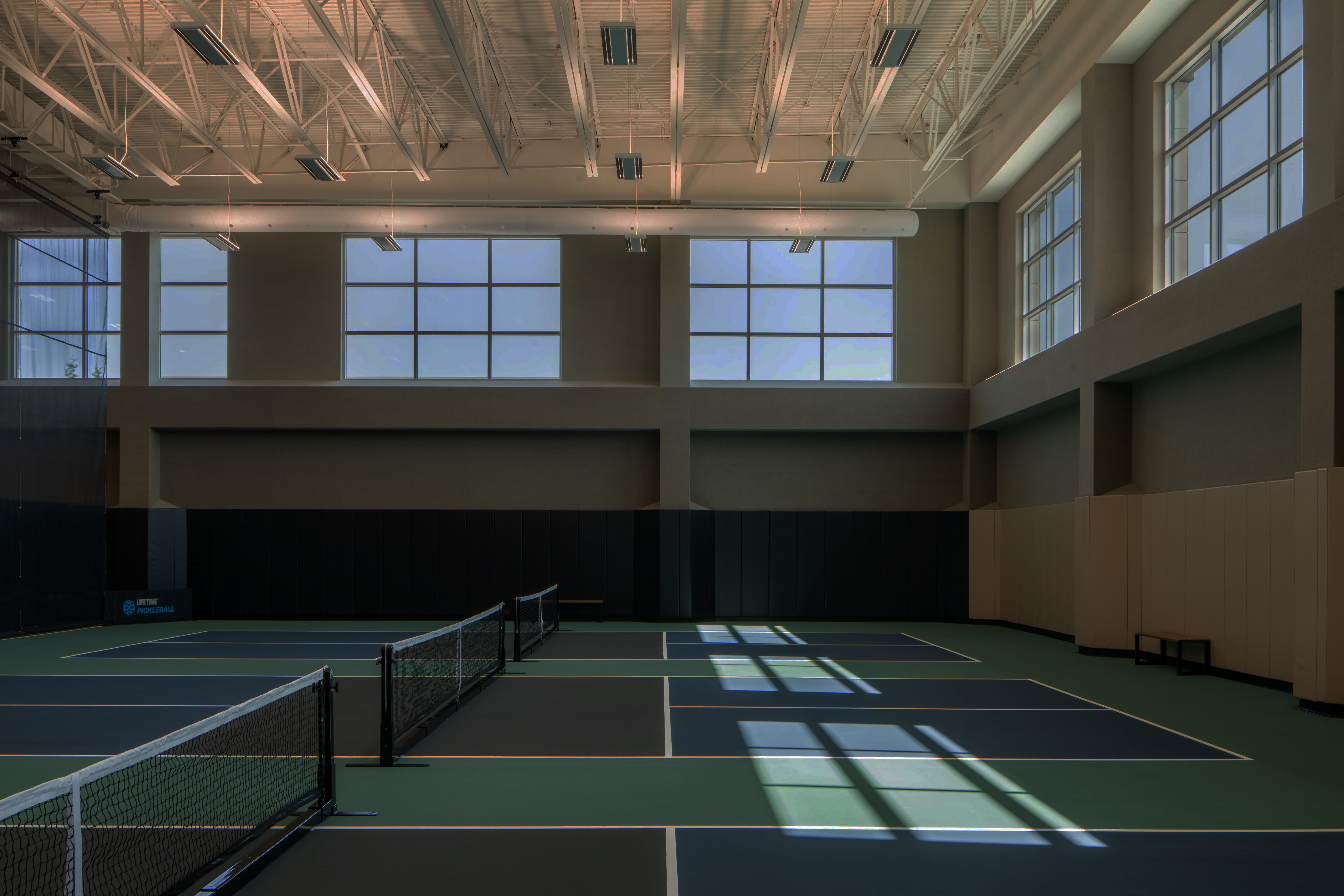 3 indoor pickleball courts in a gymnasium