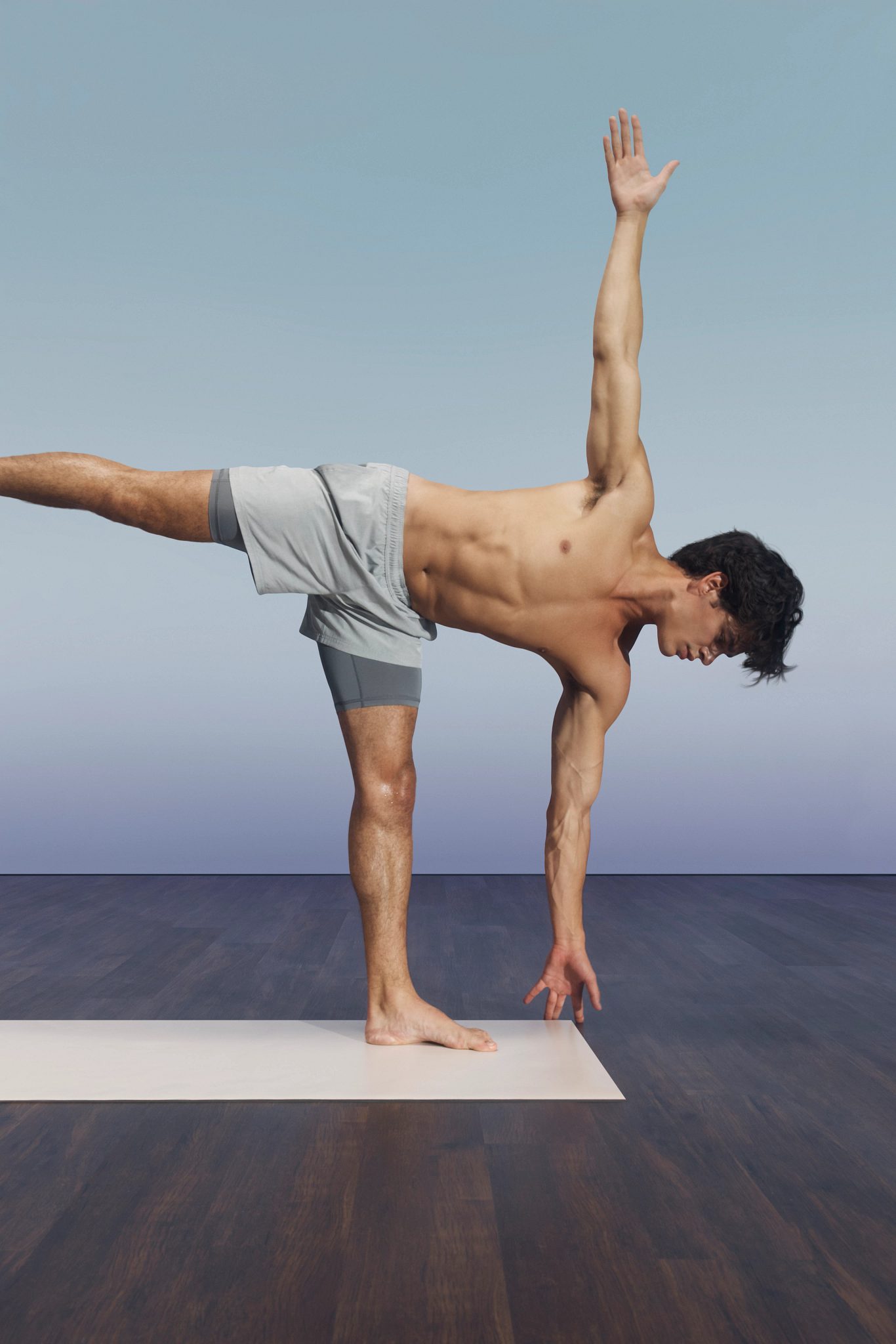 Sol yoga class participant balancing on one leg