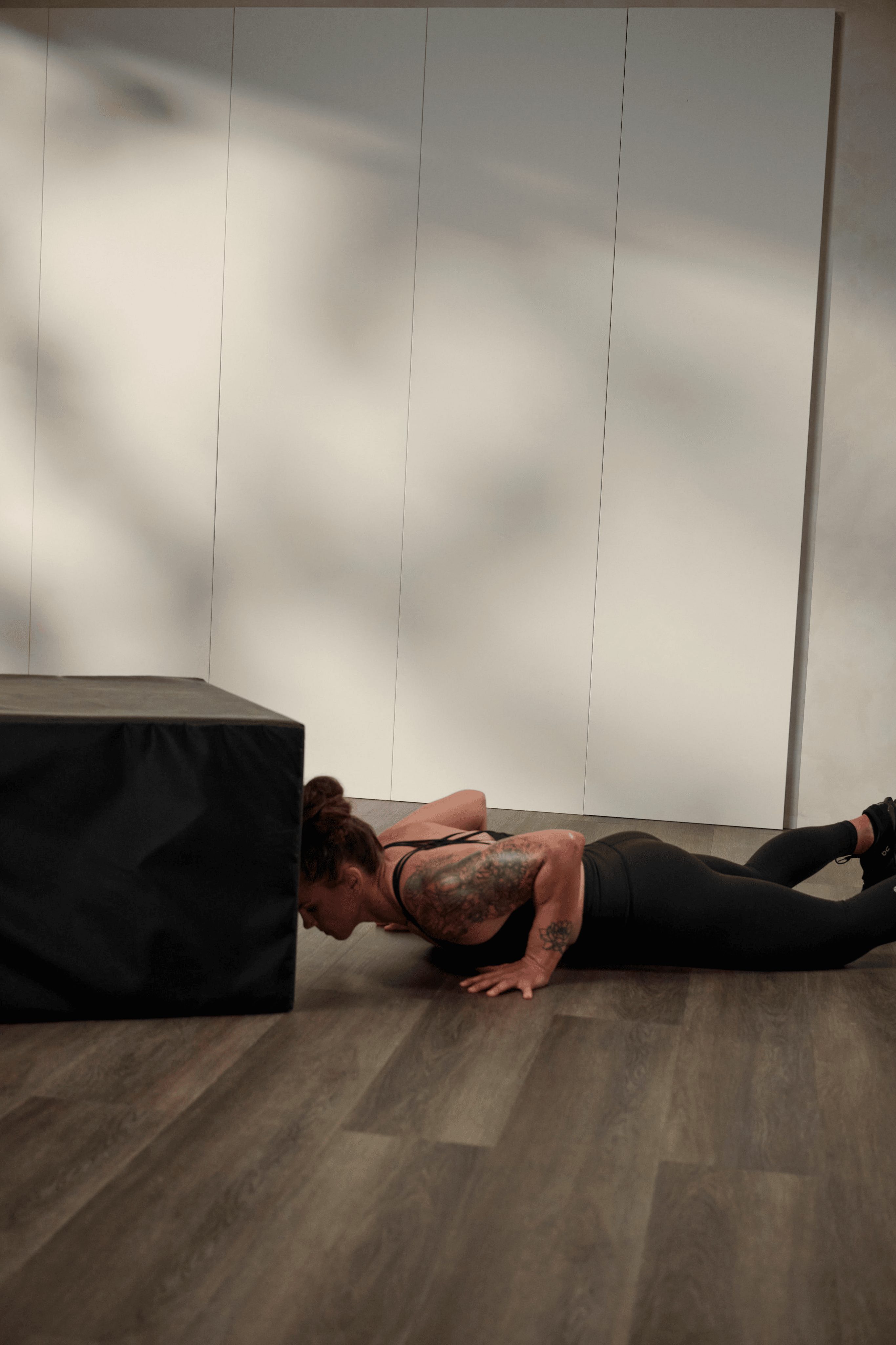 a woman doing a burpee and box jump