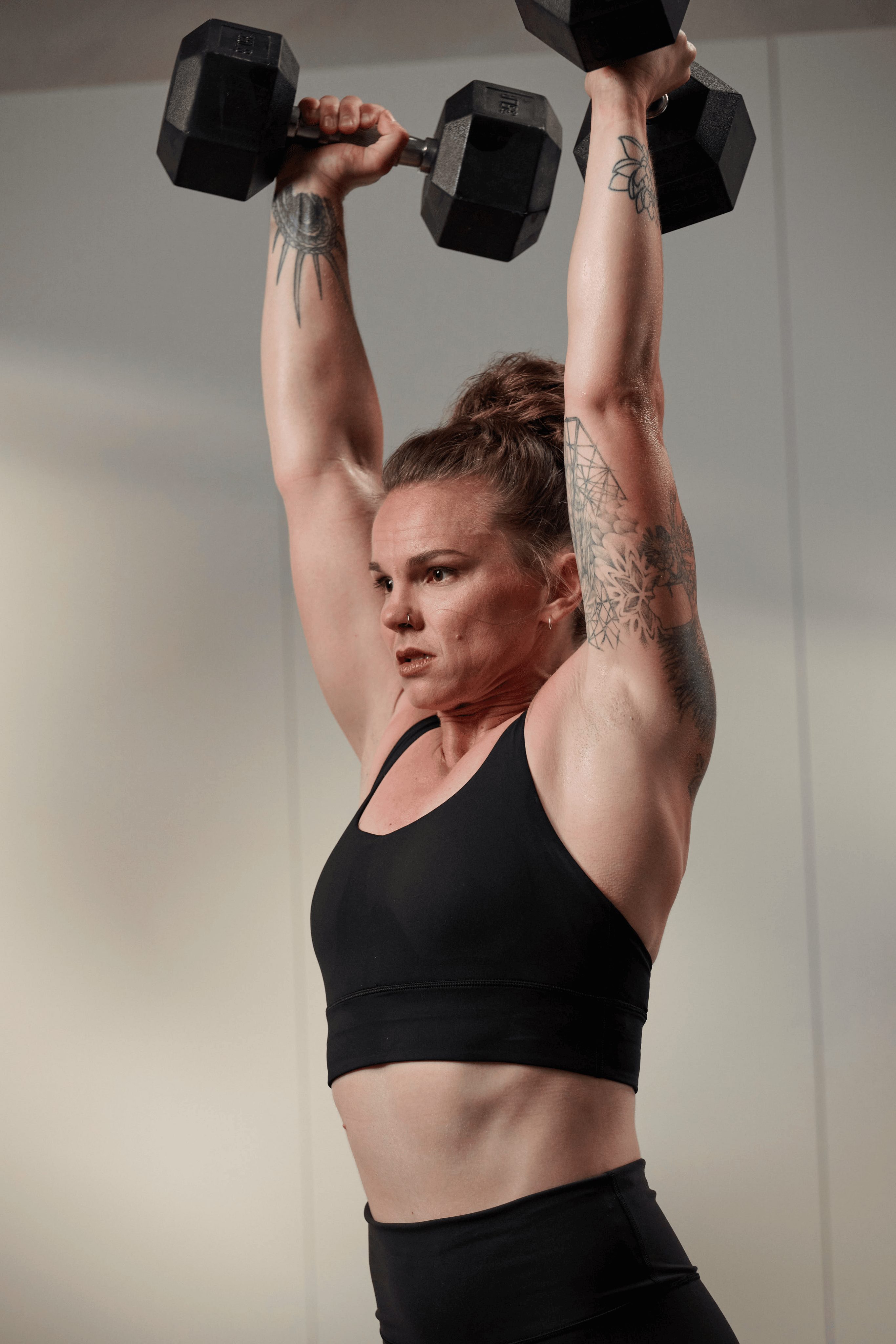a woman lifting dumbells