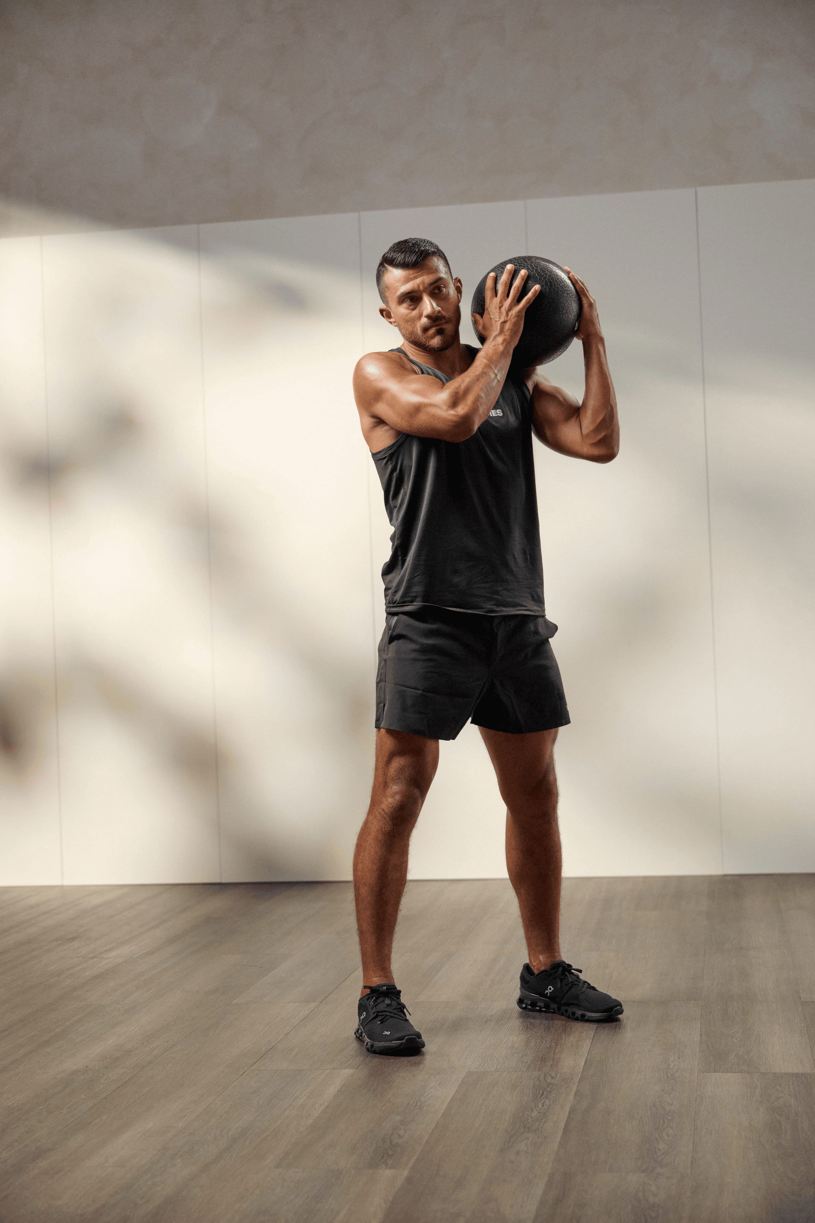 a man throwing a medicine ball over his shoulder