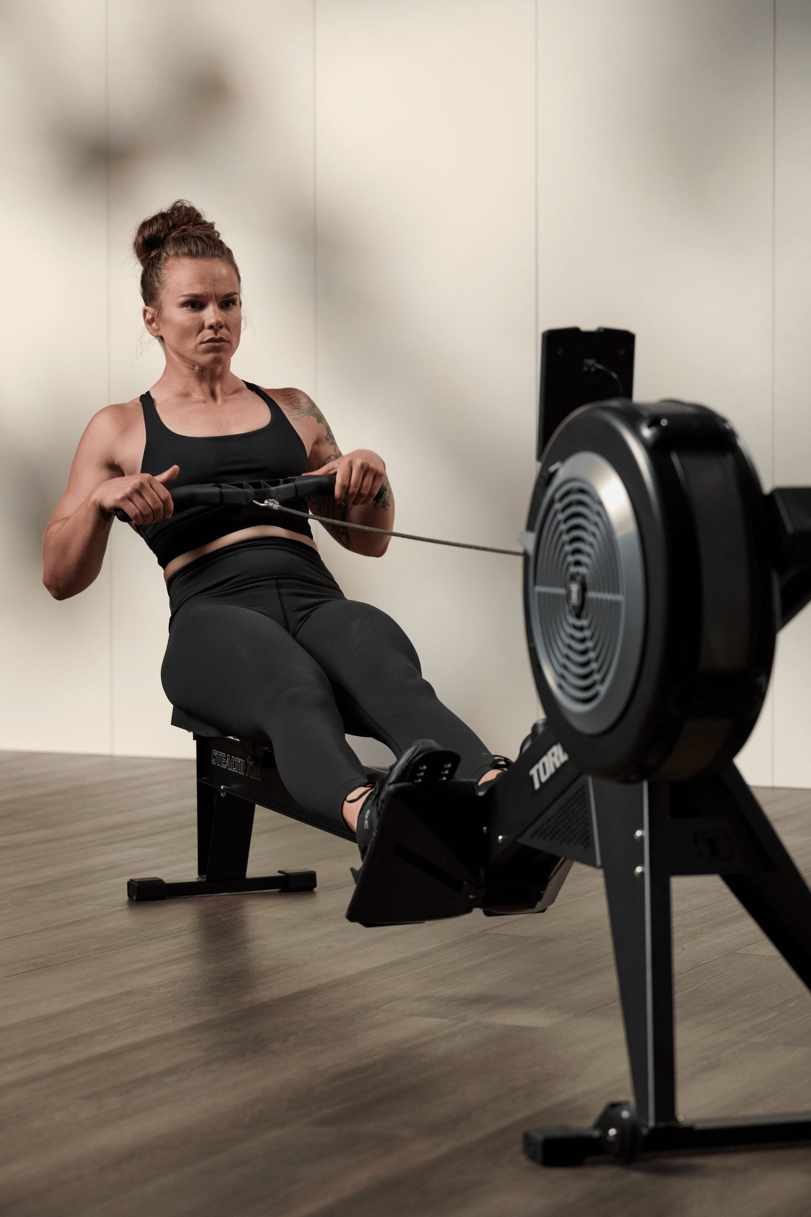 a woman using a row machine