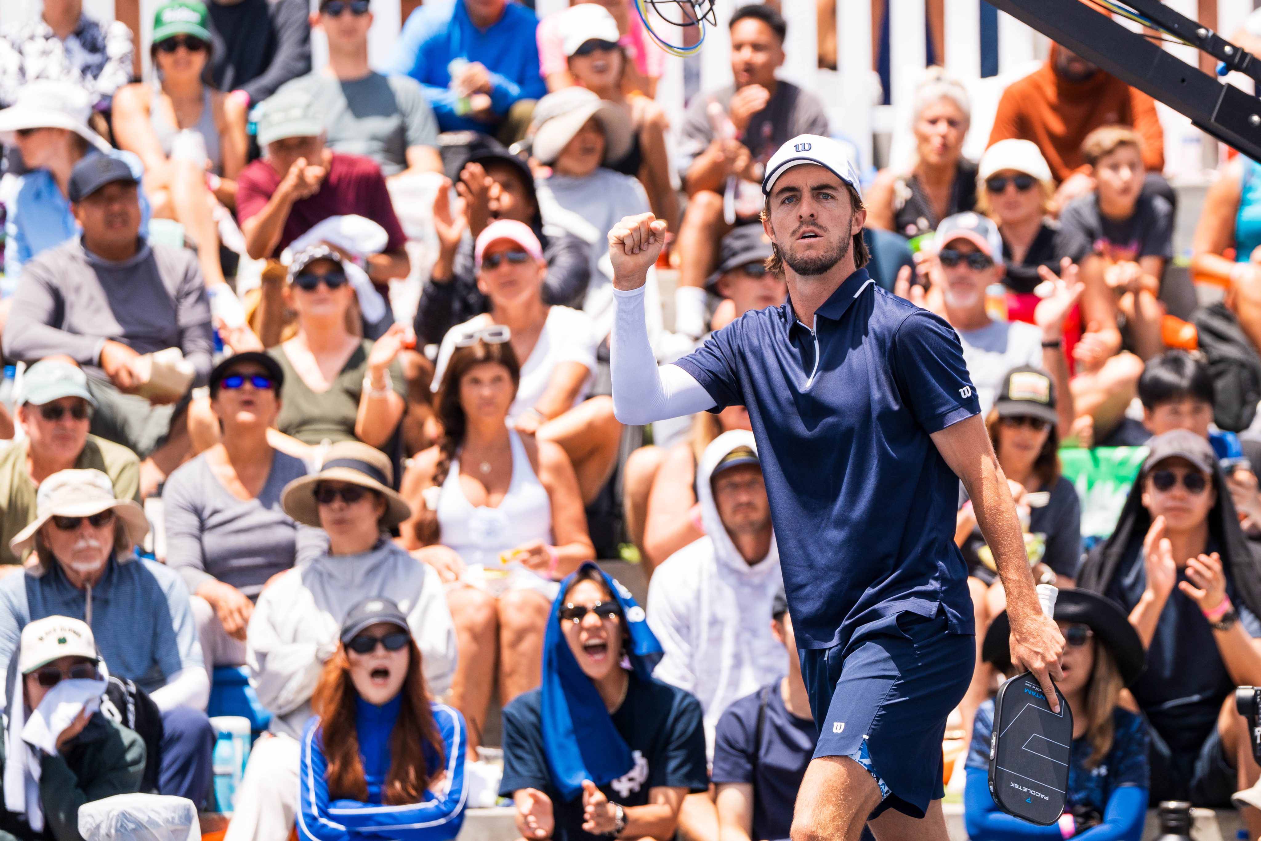 man raising his hand in victory