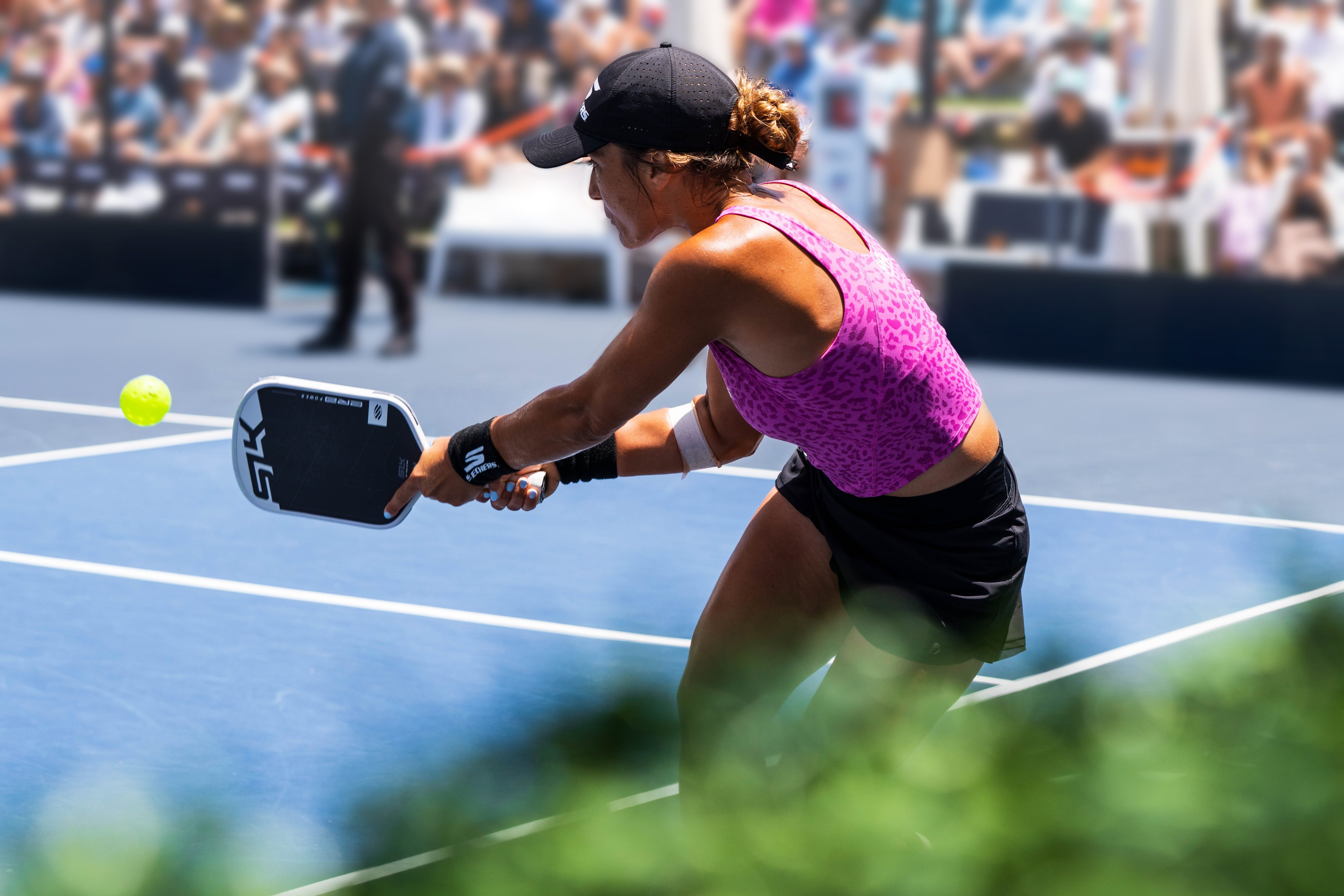 woman hitting a pickleball