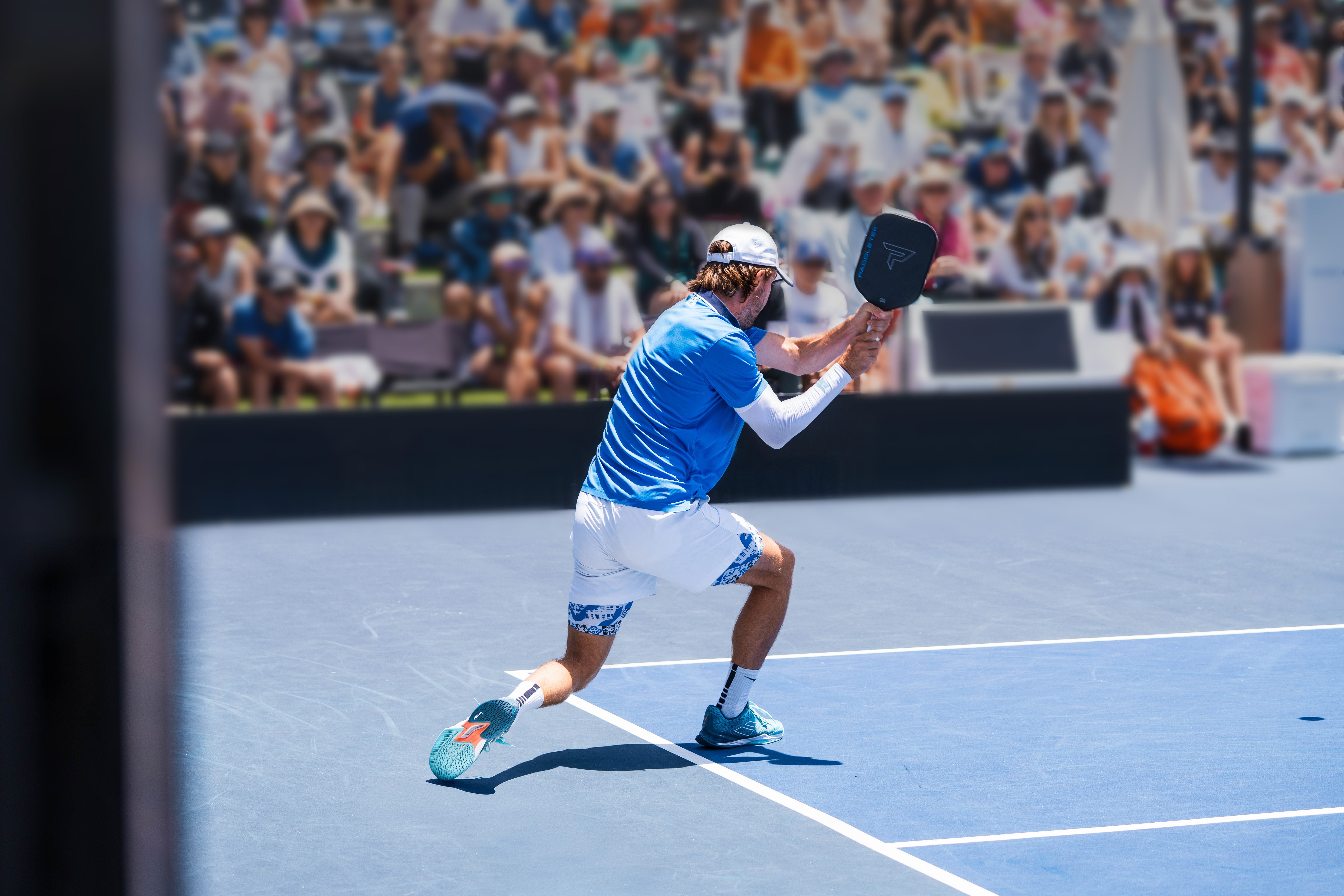 man taking a swing at a pickleball