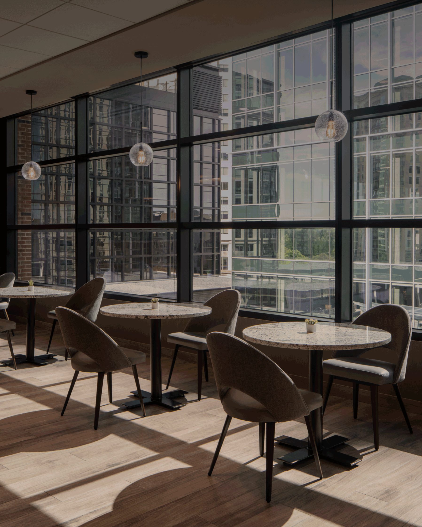 three tables with chairs surrounding in a kitchen at Life Time Work
