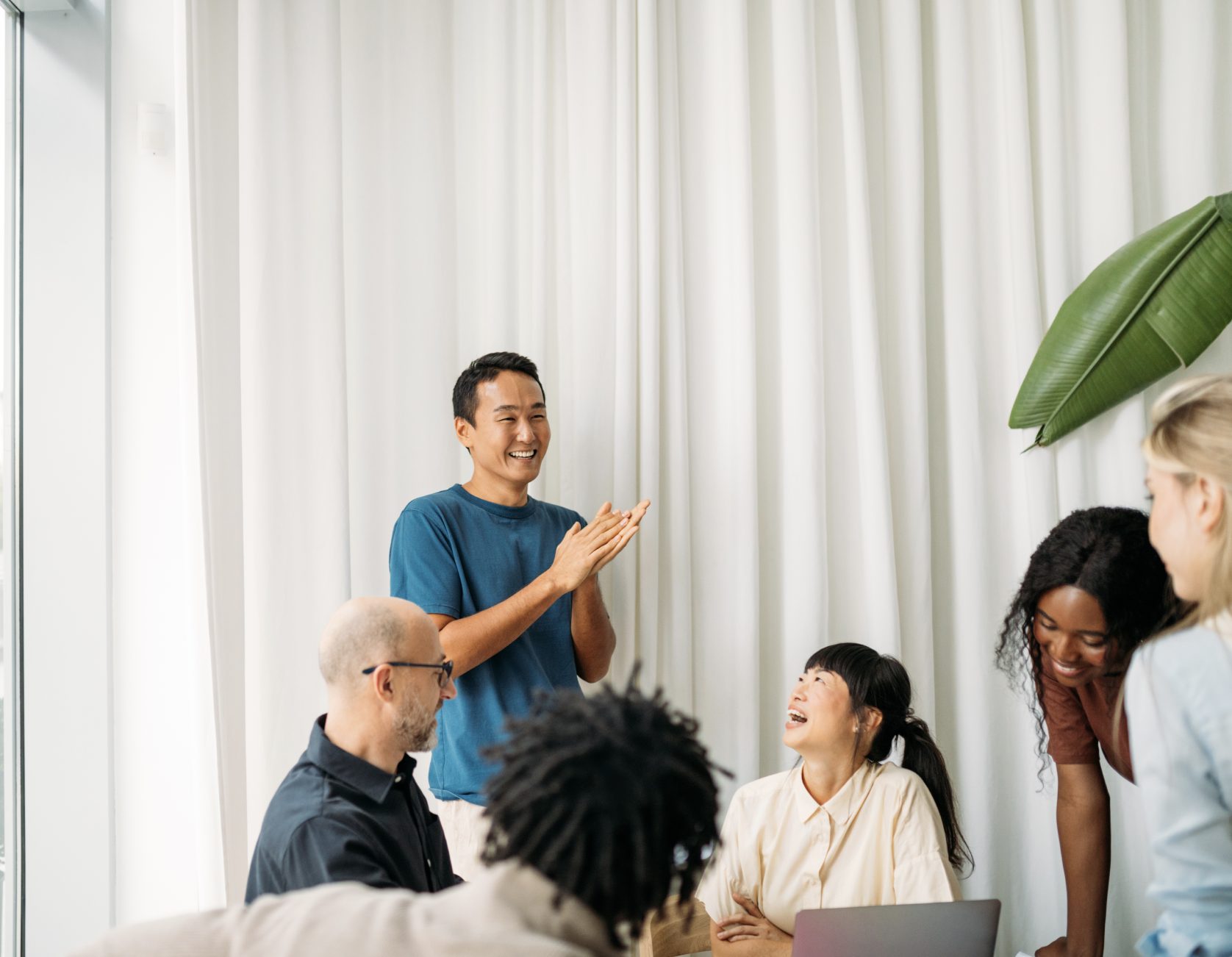 a group of people gathering around a table talking