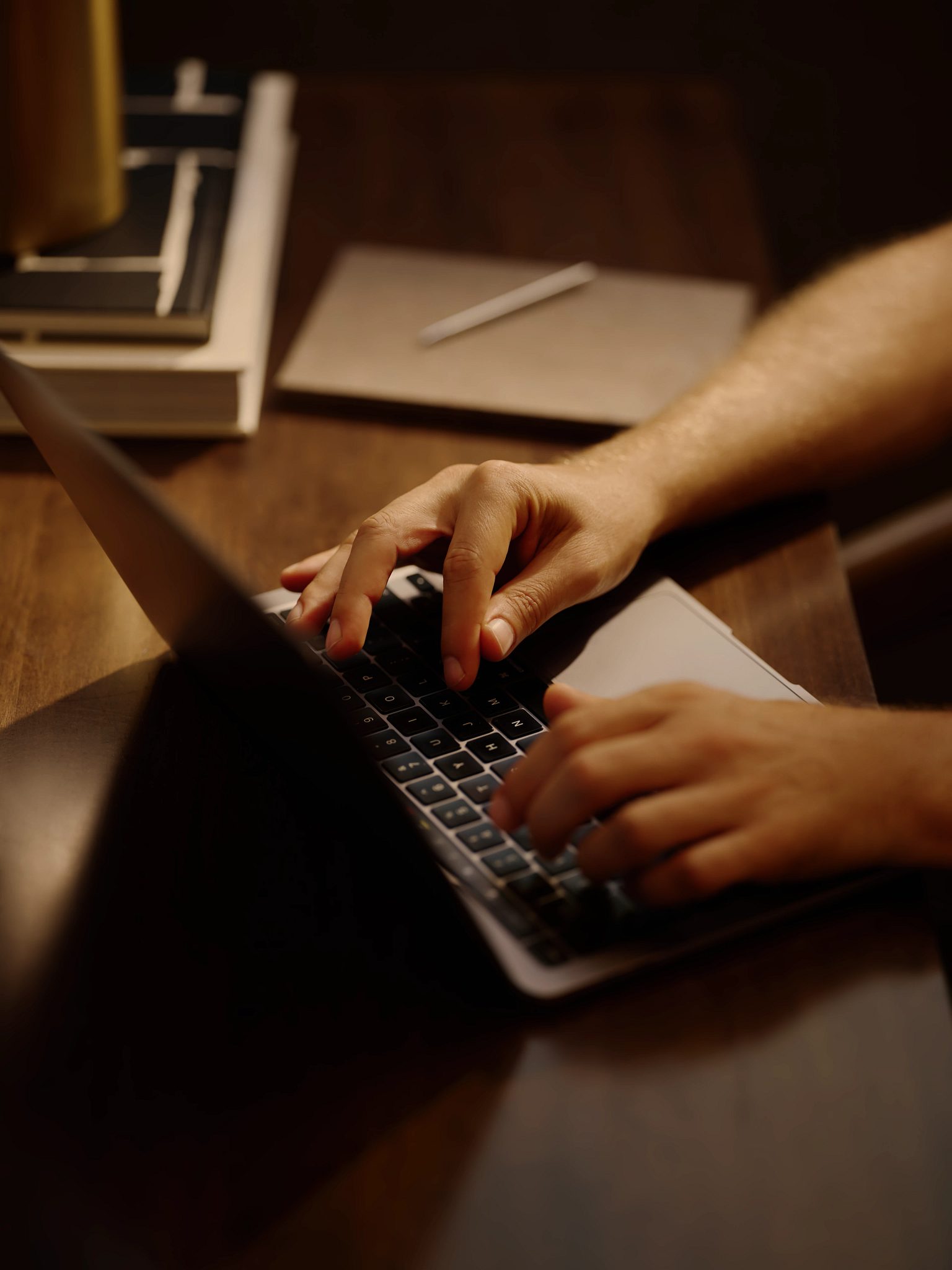Close up of hands typing on a laptop keyboard