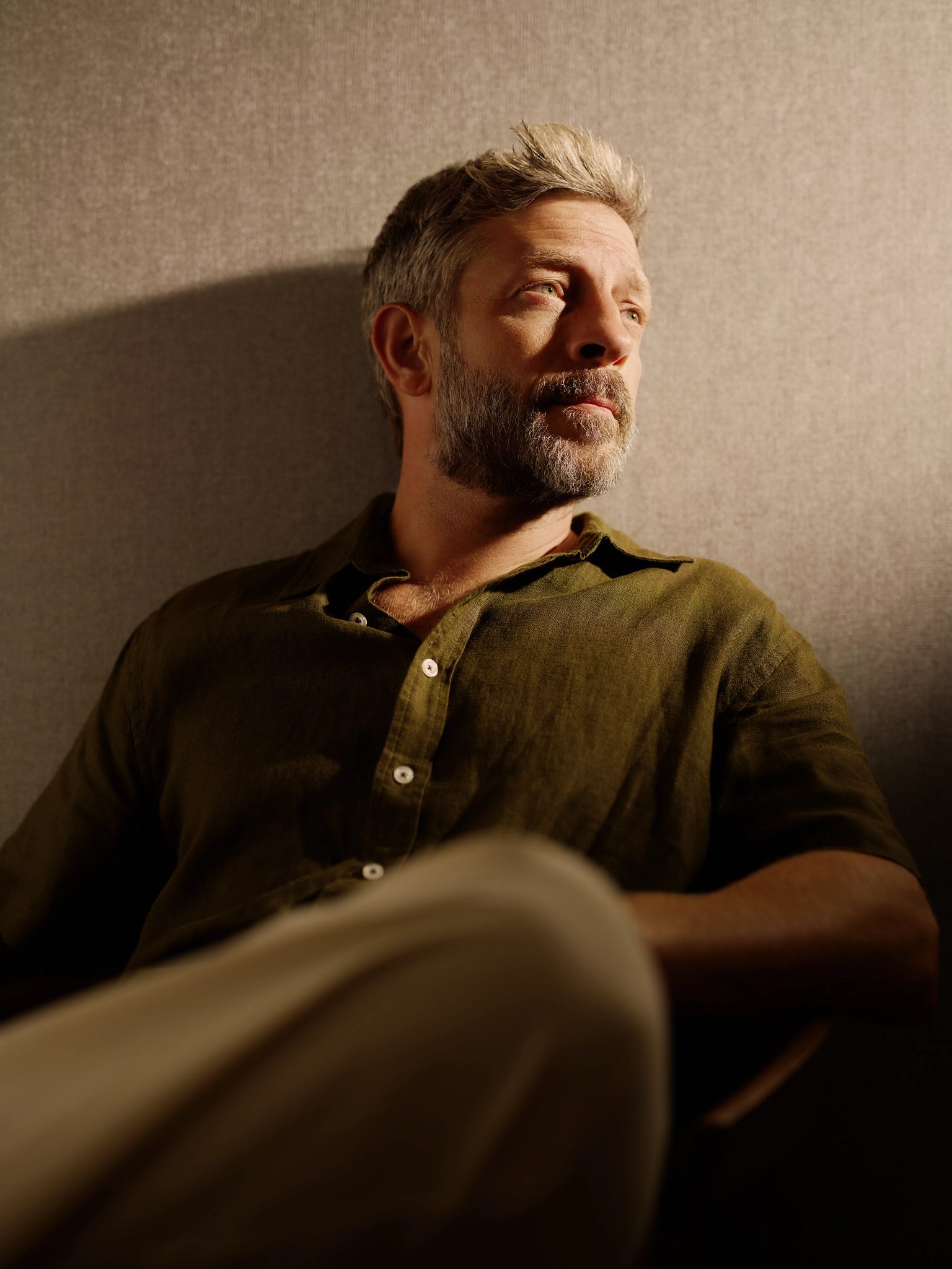 Portrait of an active-aging man sitting and looking off in the distance