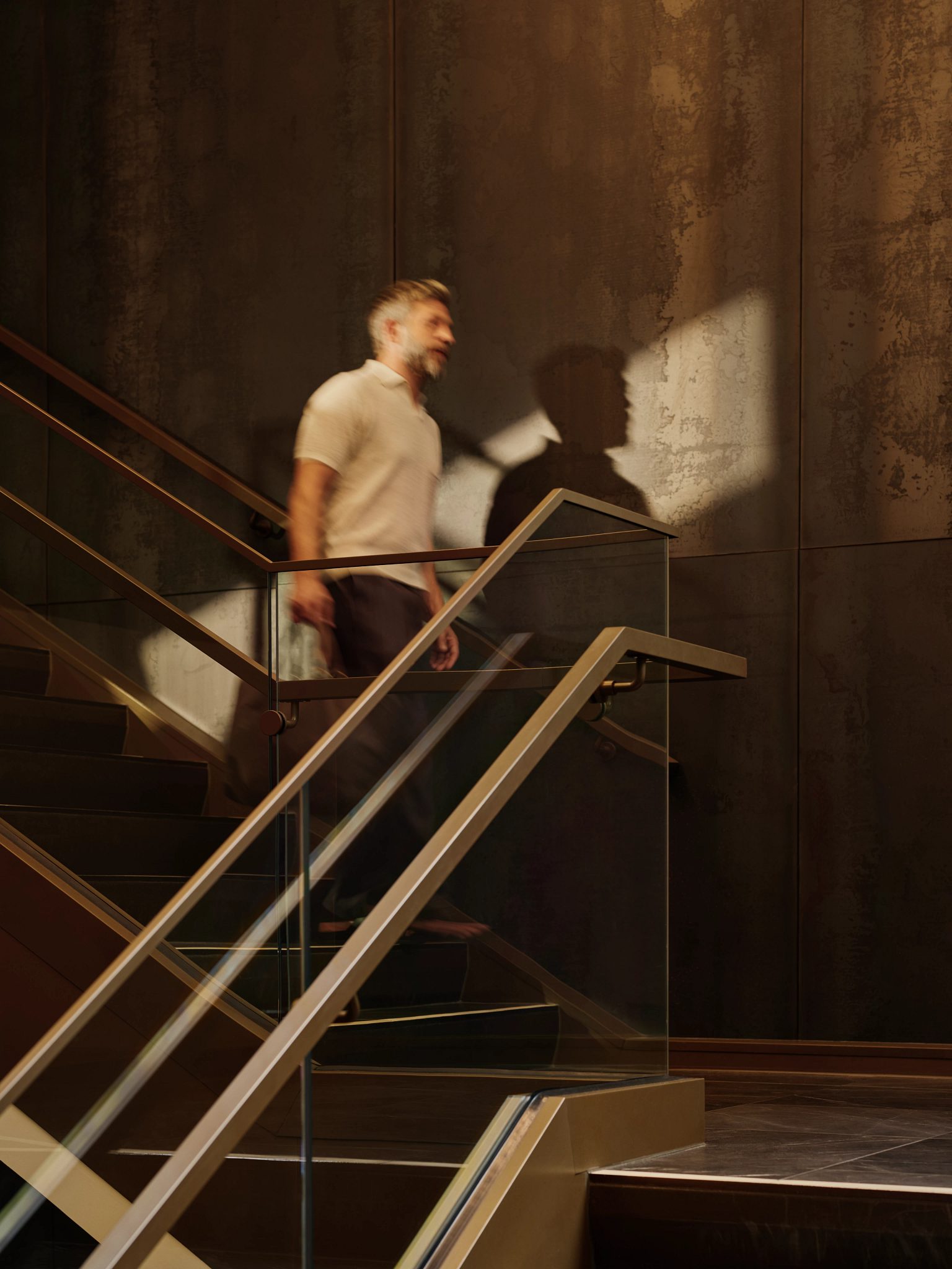 Man walking down stairs carrying a duffel bag