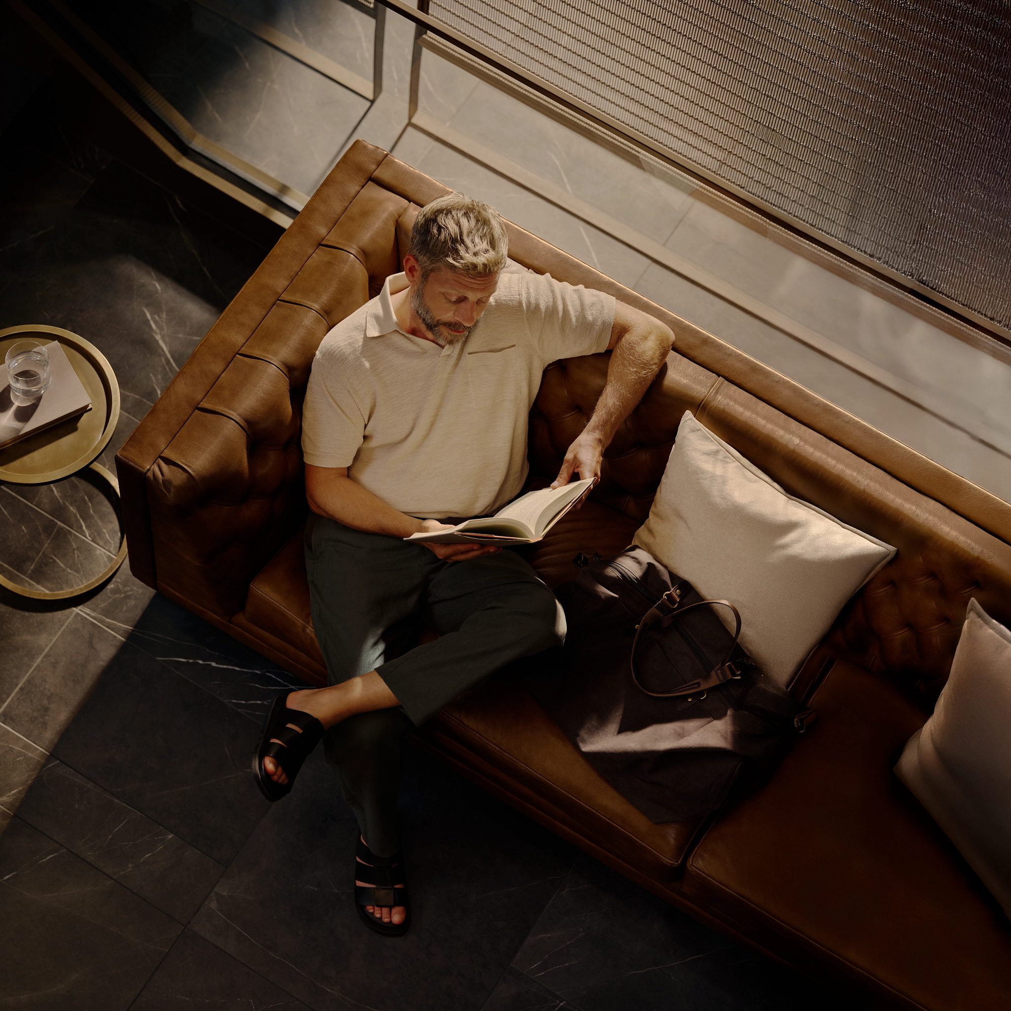 man sitting on a couch reading