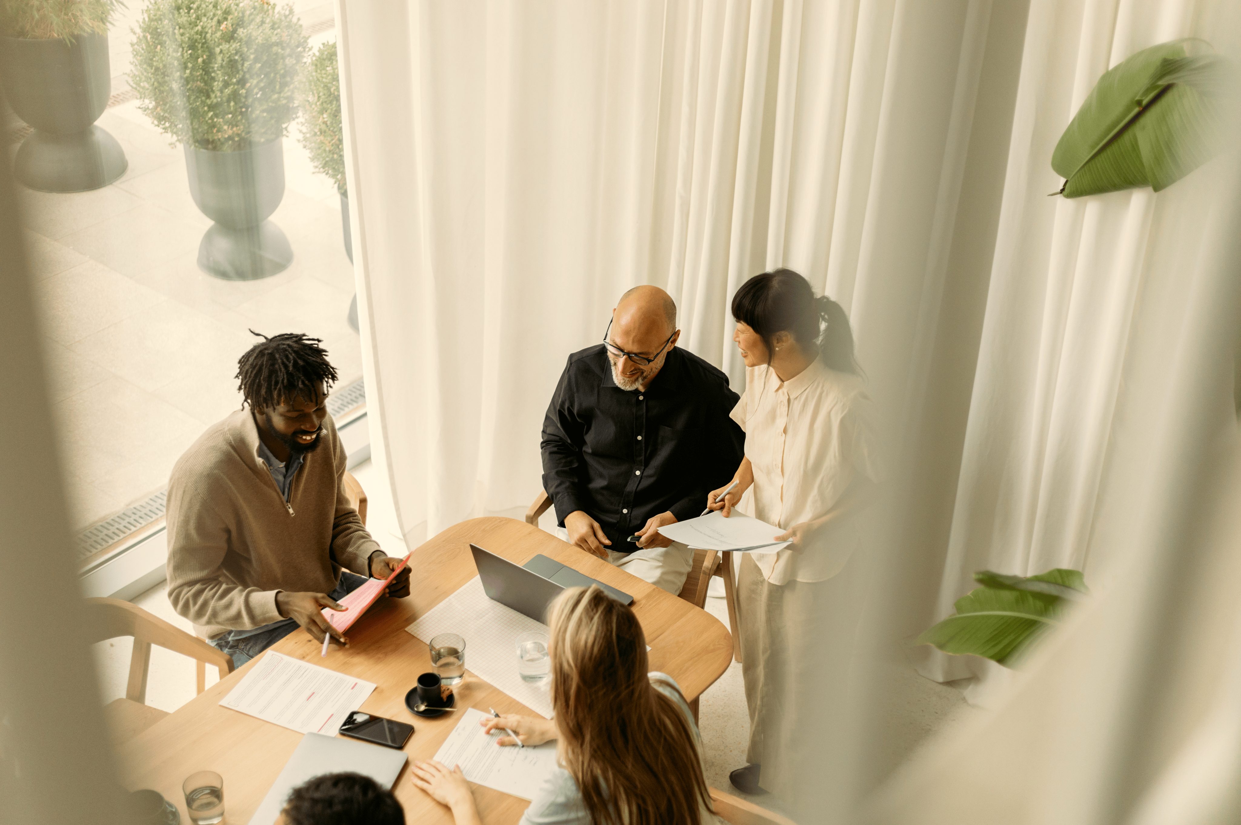 a group of people standing around a table