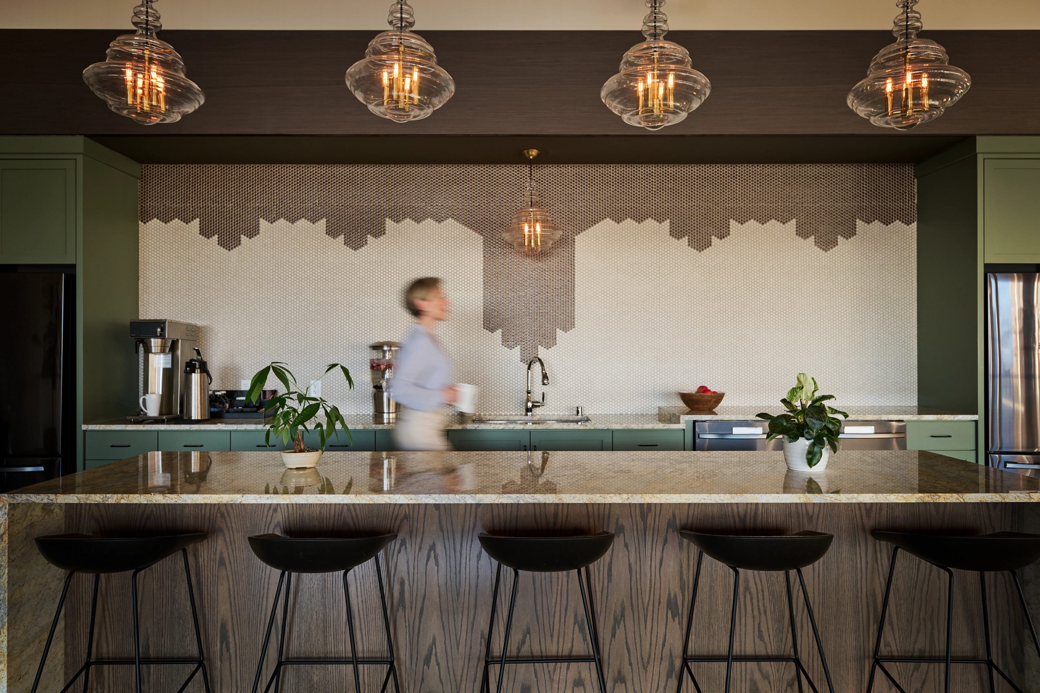 woman walking through Life Time Work kitchen