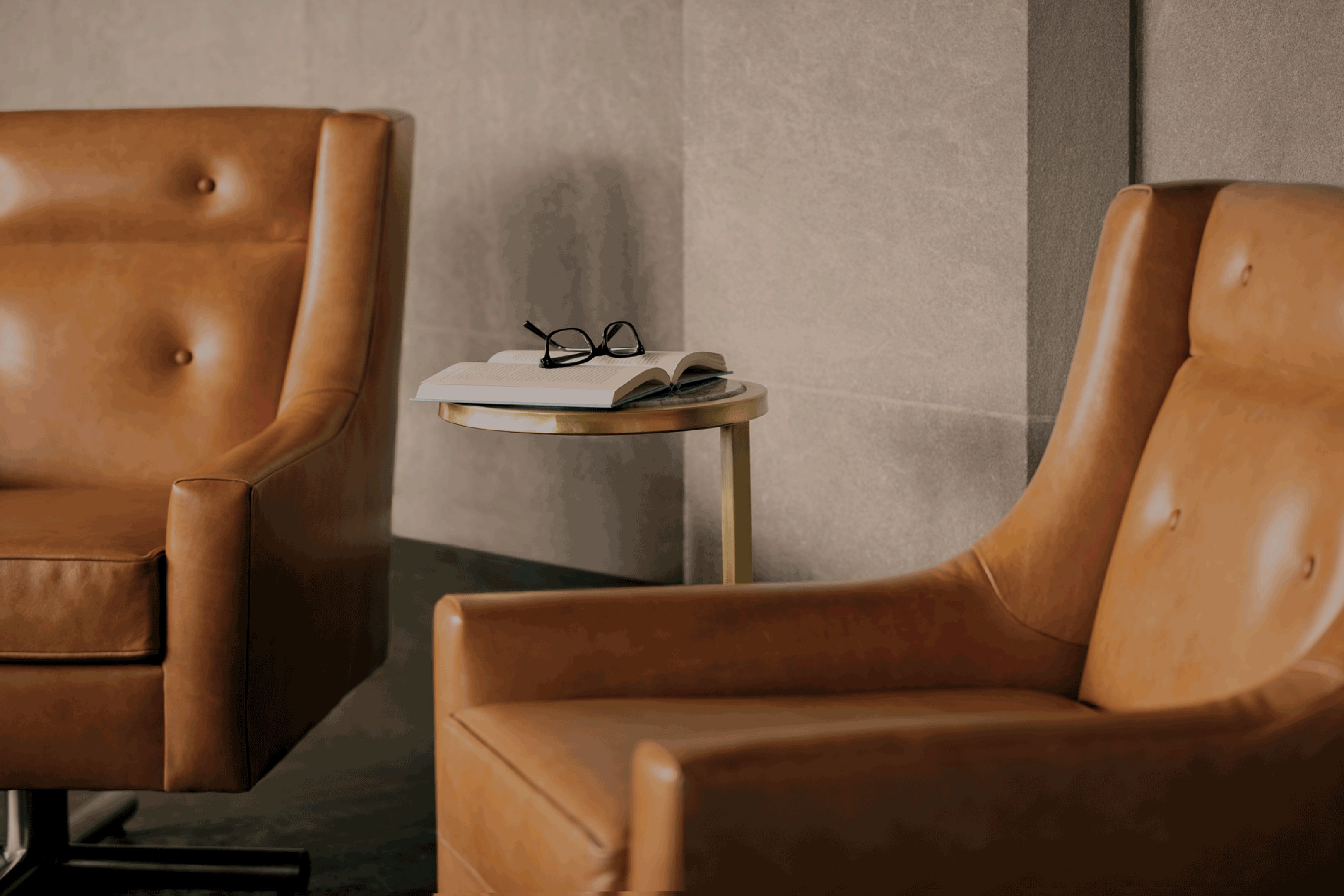 two tan leather chairs in seating area at Life Time Work Ardmore