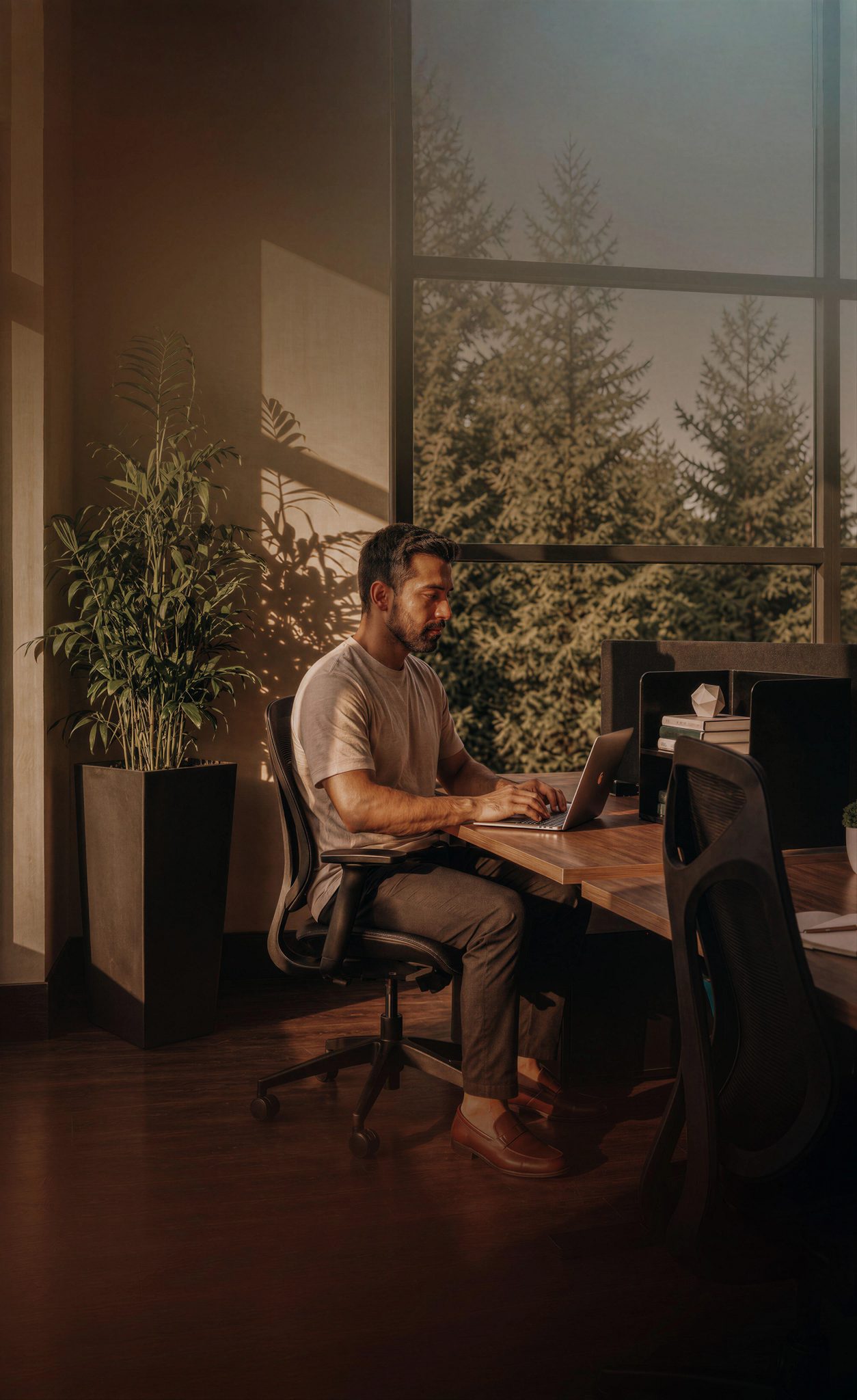 A man sitting at a desk working on his laptop