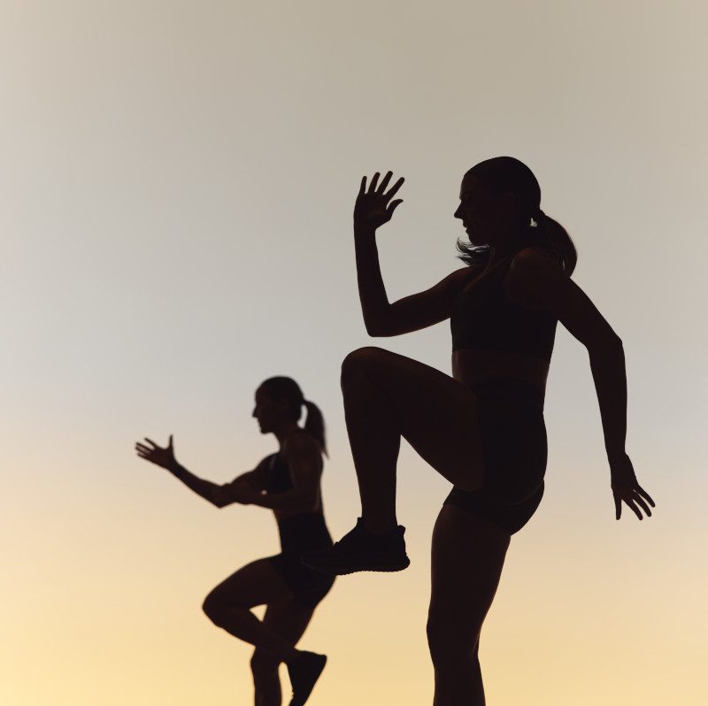 Two Life Time Xtreme cardio class members in silhouette