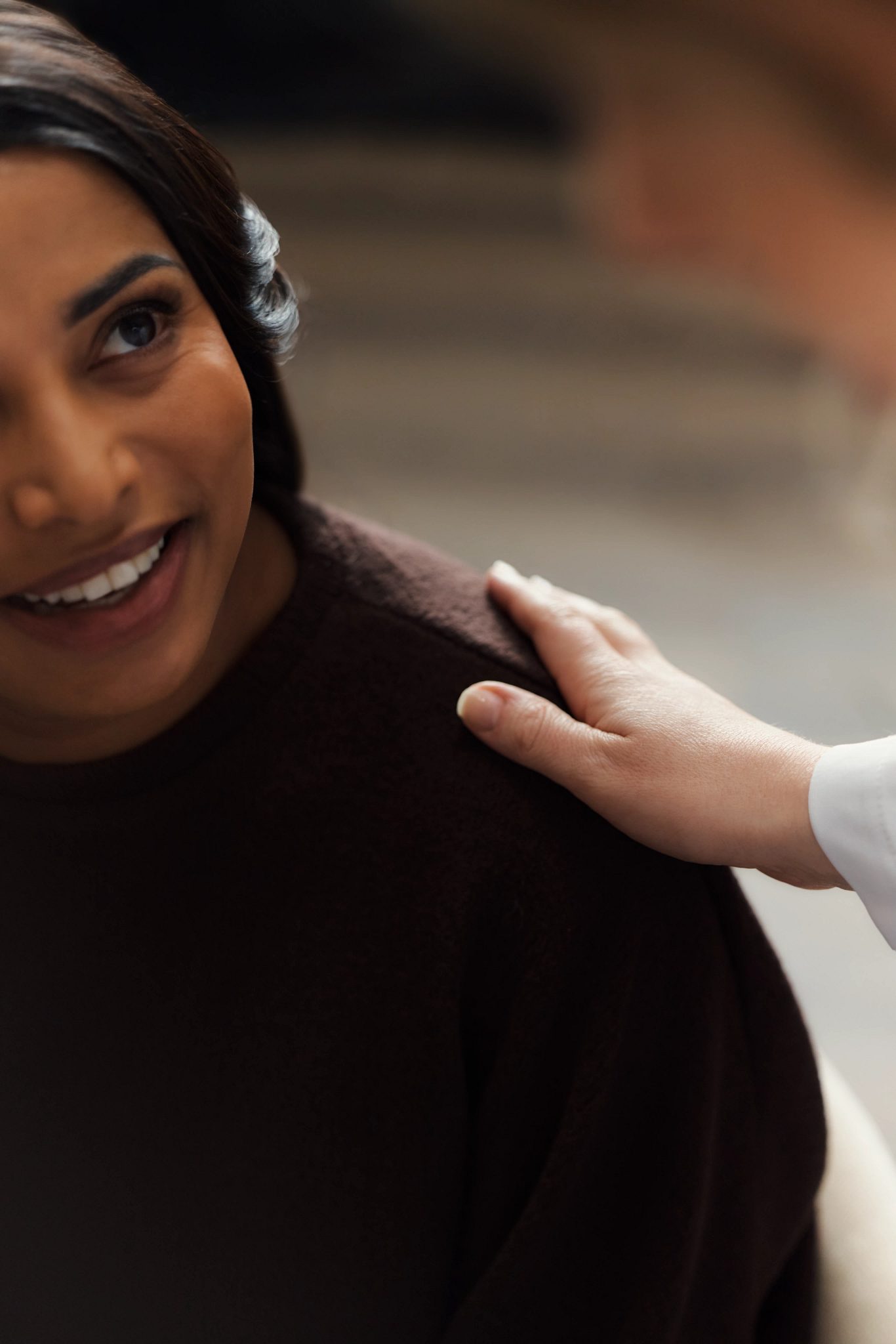 A doctors hand placed on a patients shoulder