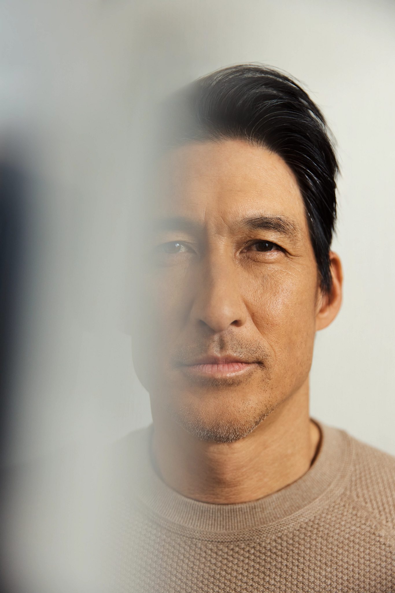 Closeup portrait of a man's face with half of it blurred