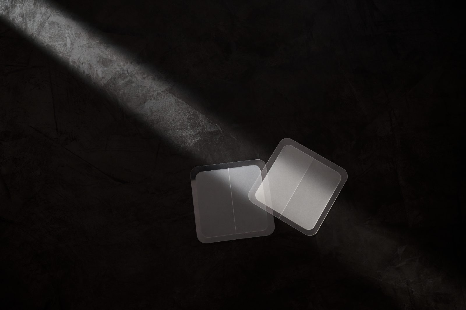 Two patches sitting on top of a dark gray background