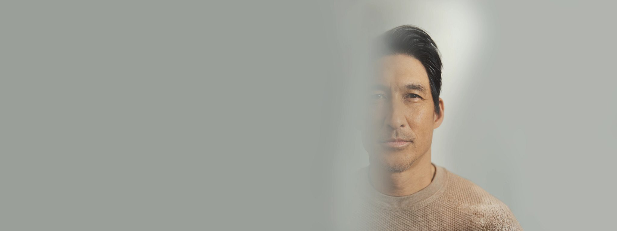 Closeup portrait of a man's face with half of it blurred