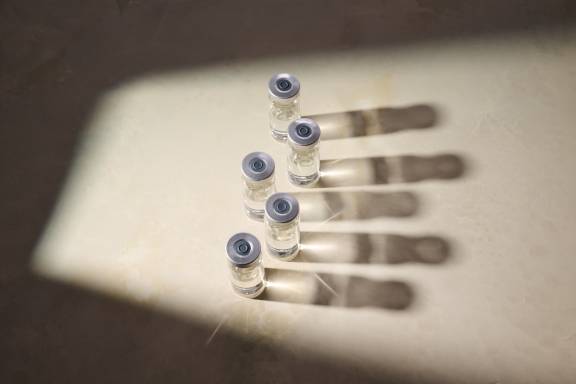 Several clear vials sitting on top of a cream-colored countertop